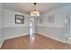 Spacious dining room featuring wood floors and stylish lighting at 2108 Valrico Heights Blvd, Valrico, FL 33594