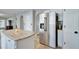 Modern kitchen with stainless steel refrigerator and granite countertops, adjacent to arched doorways at 2108 Valrico Heights Blvd, Valrico, FL 33594