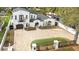 Spacious home featuring a sprawling brick driveway, manicured lawn, and charming architectural details at 2113 S West Shore Blvd, Tampa, FL 33629