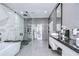 An elegant bathroom with a sleek tub, glass shower, and double vanity at 2113 S West Shore Blvd, Tampa, FL 33629