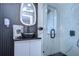 This modern bathroom features a unique sink, statement mirror, and a glass enclosed walk-in shower at 2113 S West Shore Blvd, Tampa, FL 33629