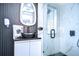 This modern bathroom features a unique sink, statement mirror, and a glass enclosed walk-in shower at 2113 S West Shore Blvd, Tampa, FL 33629