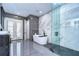 A modern bathroom featuring a sleek, freestanding tub, a glass shower, and a double door to the backyard at 2113 S West Shore Blvd, Tampa, FL 33629