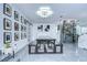 Spacious dining area with a modern light fixture, gallery wall, wine storage, and sleek tiled floors at 2113 S West Shore Blvd, Tampa, FL 33629
