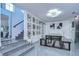 Open dining room with a modern light fixture, gallery wall, staircase, and sleek tiled floors at 2113 S West Shore Blvd, Tampa, FL 33629