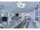 Open-concept living space with a large dining table, modern lighting, and sleek tiled flooring at 2113 S West Shore Blvd, Tampa, FL 33629