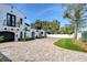 Charming home featuring a brick driveway leading to a black garage door and landscaped entryway at 2113 S West Shore Blvd, Tampa, FL 33629