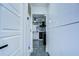 The hallway leads to a kitchen with marble countertops, stainless steel appliances, and modern lighting at 2113 S West Shore Blvd, Tampa, FL 33629