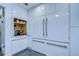 The kitchen has sleek cabinetry, a large refrigerator, stainless steel appliances, and modern lighting at 2113 S West Shore Blvd, Tampa, FL 33629