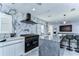 This spacious kitchen features a large island with marble backsplash, stainless steel appliances, and modern lighting at 2113 S West Shore Blvd, Tampa, FL 33629