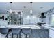 Modern kitchen with marble countertops, wine rack, stainless steel appliances, and breakfast bar with seating for three at 2113 S West Shore Blvd, Tampa, FL 33629