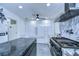 A modern kitchen featuring stainless steel appliances, marble countertops, and ample cabinet space at 2113 S West Shore Blvd, Tampa, FL 33629