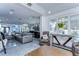 Spacious living room with tile floors, open access to the modern bar and kitchen featuring ample seating and natural light at 2113 S West Shore Blvd, Tampa, FL 33629