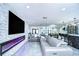 Open concept living room with a stylish stone wall, modern fireplace, and bar area at 2113 S West Shore Blvd, Tampa, FL 33629
