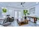Bright living room featuring tile floors, ceiling fan, neutral walls, indoor plants and natural light from the sliding glass door at 2113 S West Shore Blvd, Tampa, FL 33629