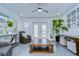 Bright living room featuring tile floors, ceiling fan, neutral walls, indoor plants and natural light from the sliding glass door at 2113 S West Shore Blvd, Tampa, FL 33629