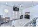 An elegant bedroom with a TV, massage chair, and doors to a balcony at 2113 S West Shore Blvd, Tampa, FL 33629