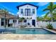 Charming two-story home featuring a refreshing pool, spa, and outdoor area under a sunny sky at 2113 S West Shore Blvd, Tampa, FL 33629