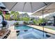 Private backyard featuring a pool, spa, lush landscaping and outdoor kitchen at 2113 S West Shore Blvd, Tampa, FL 33629