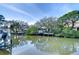 Picturesque waterfront property boasts a dock with boatlift amidst lush foliage and serene water at 2113 S West Shore Blvd, Tampa, FL 33629
