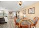 Bright dining area featuring a round wooden table, charming decor, and plenty of natural light at 2146 Society Dr, Holiday, FL 34691