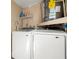 Functional laundry area with modern washer and dryer and a hot water heater at 2146 Society Dr, Holiday, FL 34691