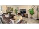 Inviting living room featuring stylish decor, a large leather sectional, and warm, neutral tones at 2146 Society Dr, Holiday, FL 34691