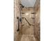 Updated shower with stone-look walls, shower caddy shelves and safety bars at 2146 Society Dr, Holiday, FL 34691
