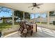 Enclosed patio features an outdoor dining set and waterfront views at 2146 Society Dr, Holiday, FL 34691