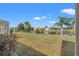 A spacious backyard overlooking a serene pond provides a peaceful outdoor setting at 2250 Long View Cir, Brooksville, FL 34604