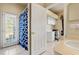 Bathroom with access to the backyard and a separate area, and white cabinets at 2250 Long View Cir, Brooksville, FL 34604