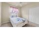 Cozy bedroom includes a comfortable bed, carpeted floor, a ceiling fan, and a window with natural light at 2250 Long View Cir, Brooksville, FL 34604