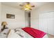 Bedroom with a ceiling fan, closet, side table and a window at 2250 Long View Cir, Brooksville, FL 34604