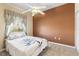 Cozy bedroom with a ceiling fan, a window with curtains, carpet and an accent wall at 2250 Long View Cir, Brooksville, FL 34604