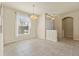 Open dining room space with a large window, elegant chandelier, and tile flooring creating a welcoming atmosphere at 2250 Long View Cir, Brooksville, FL 34604