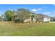 Charming home with landscaped front yard, three car garage, and palm trees at 2250 Long View Cir, Brooksville, FL 34604