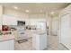 Bright kitchen featuring white cabinets, appliances, and tiled flooring at 2250 Long View Cir, Brooksville, FL 34604