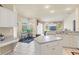 Bright kitchen featuring white cabinets, a cozy breakfast nook and views into the living room at 2250 Long View Cir, Brooksville, FL 34604