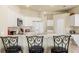 Bright kitchen with white cabinets and a breakfast bar with seating at 2250 Long View Cir, Brooksville, FL 34604
