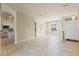 Neutral living room with tile flooring, large window, and open-concept kitchen in the background at 2250 Long View Cir, Brooksville, FL 34604