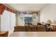 Cozy living room with comfortable seating, large windows, and a ceiling fan at 2250 Long View Cir, Brooksville, FL 34604