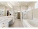 Spacious main bathroom features dual vanities, a soaking tub, a glass-enclosed shower and plenty of natural light at 2250 Long View Cir, Brooksville, FL 34604