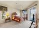 Inviting main bedroom with a ceiling fan, plush carpeting, and sliding glass doors leading to a screened lanai at 2250 Long View Cir, Brooksville, FL 34604