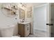 Bright bathroom with modern vanity, decorative shelving, and stylish floral art at 2403 Hawthorne Rd, Spring Hill, FL 34609