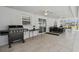 Covered patio featuring tile flooring, ceiling fans, dining set, and grill for outdoor entertaining and relaxation at 2403 Hawthorne Rd, Spring Hill, FL 34609