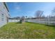 Well-maintained backyard with a white fence, ' play set, and lush green lawn at 3025 Chessington Dr, Land O Lakes, FL 34638
