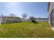 Spacious fenced backyard featuring a play set and lush green grass, perfect for outdoor activities at 3025 Chessington Dr, Land O Lakes, FL 34638