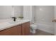 Bright bathroom with wood vanity and tiled tub at 3025 Chessington Dr, Land O Lakes, FL 34638