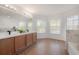 Bathroom featuring double vanity, large mirror, tile floors, and garden tub at 3025 Chessington Dr, Land O Lakes, FL 34638