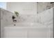 Elegant bathroom featuring a luxurious soaking tub with decorative marble tile surround at 3025 Chessington Dr, Land O Lakes, FL 34638
